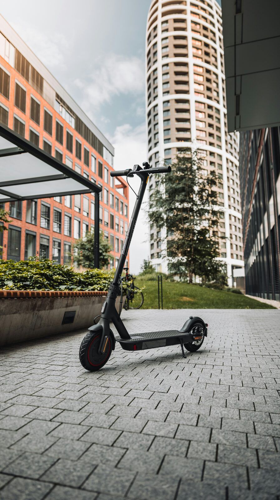 A shared electric scooter parked on a city sidewalk