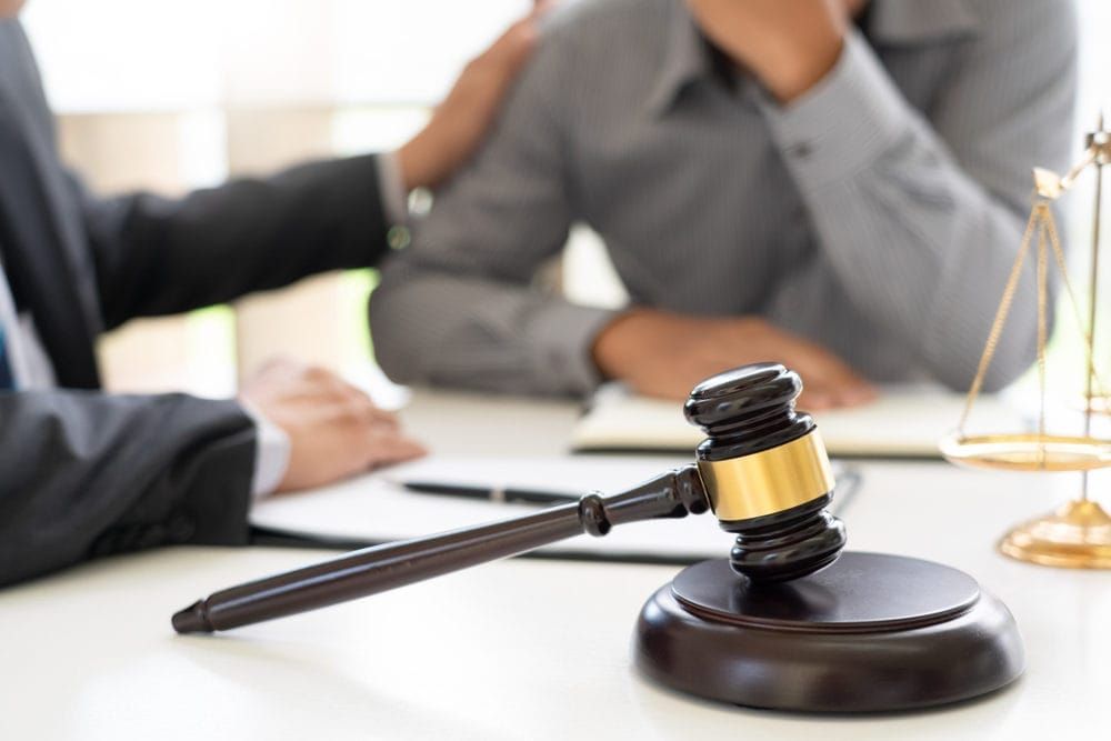 Lawyer having meeting and consoling his client to provide legal advice solution